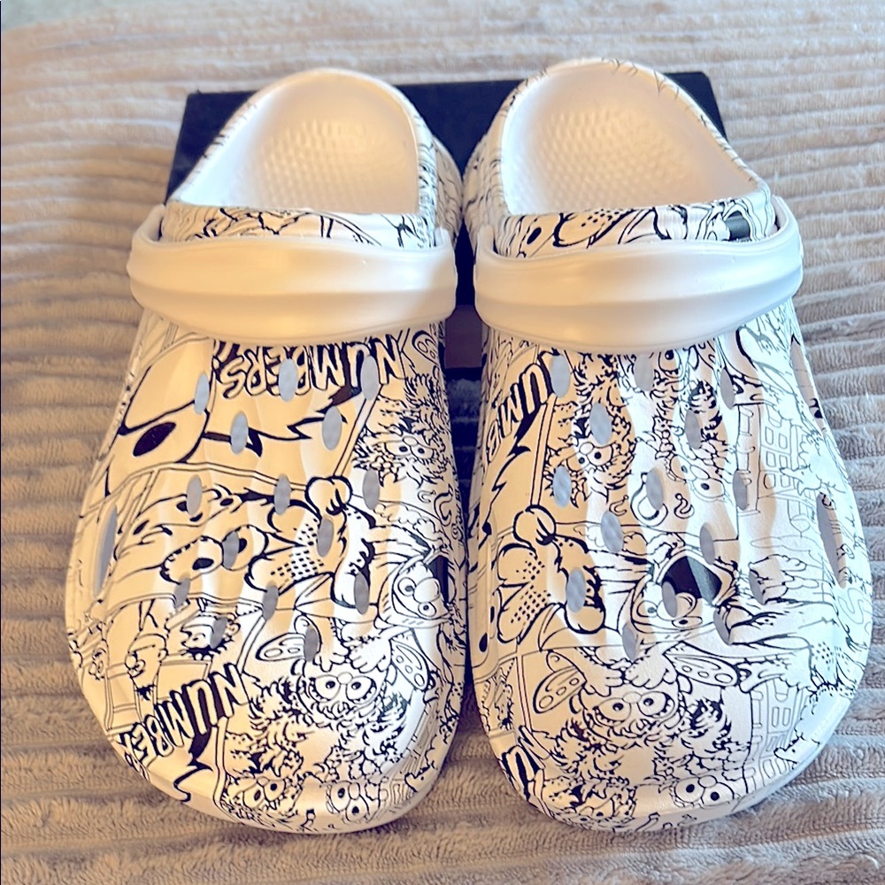 Ladies/mens cartoon print clogs, size 42, men’s size 9, women’s size 11.